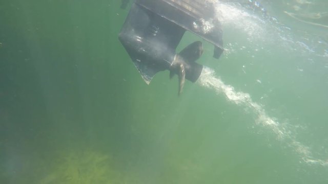 Closeup underwater shot of a boat crusing across a lake
