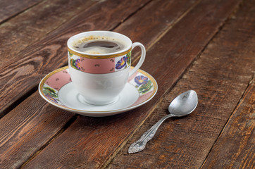 Coffee cup with spoon on dark wood table