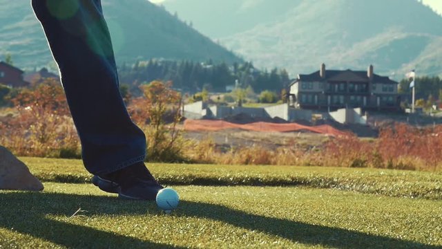 Slow motion of a man playing golf on the golf course