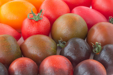 Tomatoes of different colors closeup. Top view.