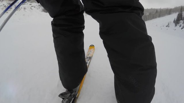 A low gimbal shot of skis going down mountain