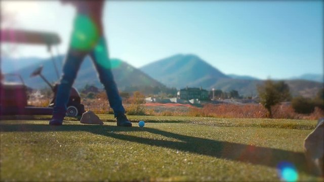 Slow motion man playing golf on the golf course