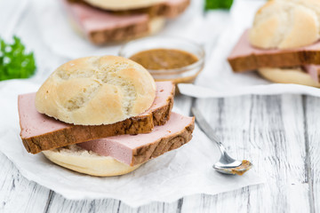 Portion of German Leberkaese on wooden background (selective foc