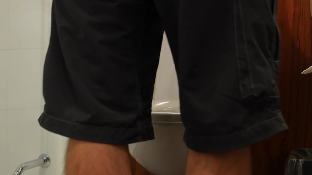 Man goes to the bathroom while standing