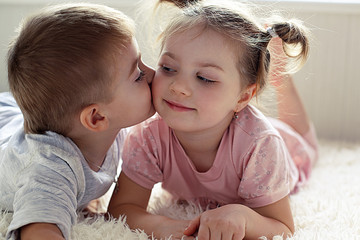 little boy and girl resting on the bed © tata_cos