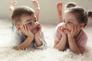 little boy and girl resting on the bed
