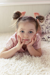 Fototapeta premium little girl lying on the sofa