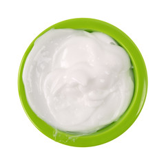 Messy bowl of vitamin E lotion isolated on a white background.