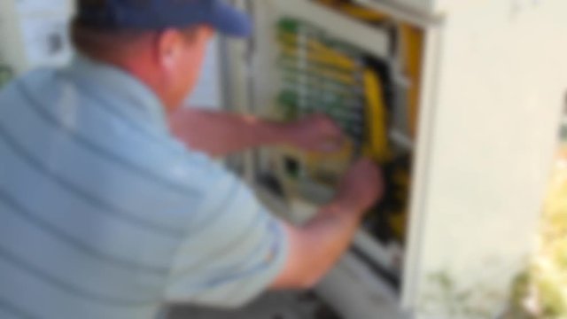 Tech works in the telecommunications outdoor box