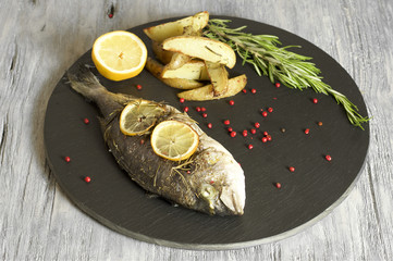 Baked dorado with rosemary baked potato wedges 