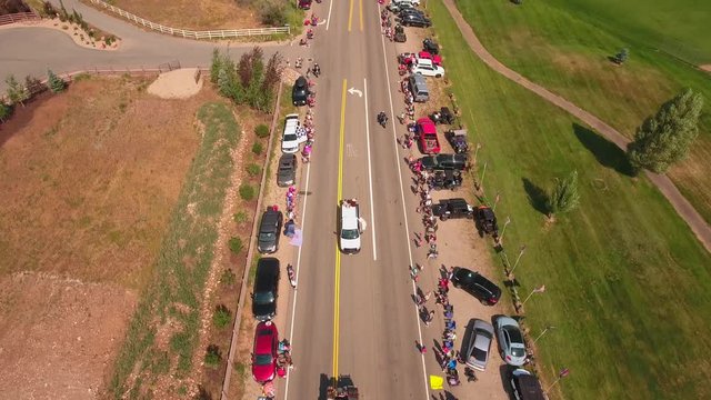 Aerial shot of people watching a small town parade in Utah