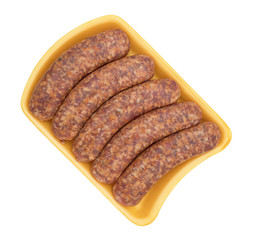 Bratwurst links on a yellow foam tray top view isolated on a white background.