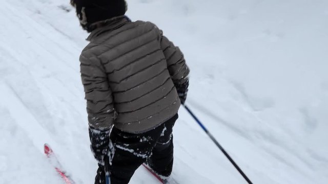 A Little Boy Cross Country Skiing In The New Snow