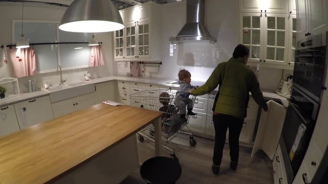 A woman with her kids looking at furniture