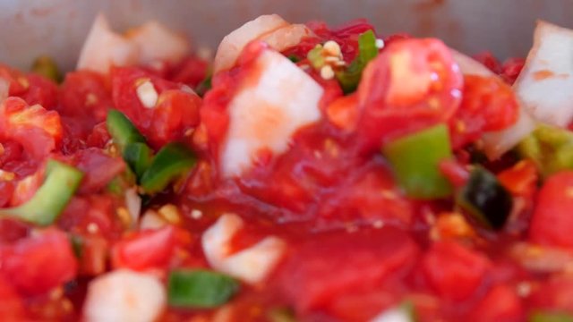 Stiring a fresh pot of vegetable salsa