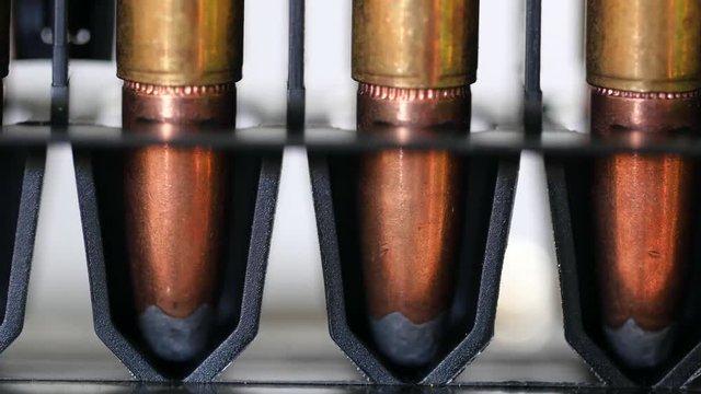 A Dolly shot of large caliber bullets in production line