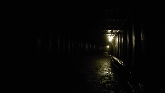 Camera panning shot through a dark coal mine in glace bay