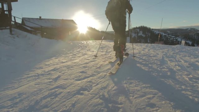A man ski tours in early morning light