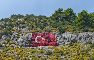 Турецкий флаг, нарисованный в горах города Финикия, Анталия. Турция.