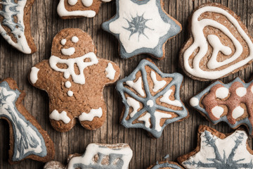 Colorfully Christmas cookies on rustic wooden background, gingerman and tree