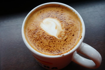 Cup of vegan non-dairy cappuccino coffee with almond milk