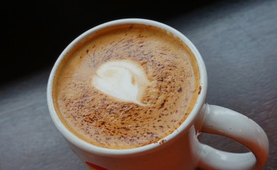 Cup of vegan non-dairy cappuccino coffee with almond milk