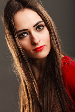 woman long straight hair dark makeup red lips on gray