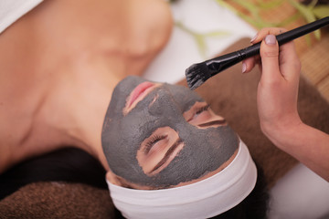 Spa Mud Mask. Woman in Spa Salon. Face Mask. Facial Clay Mask. Treatment