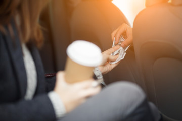 Female passenger in taxi paying the driver for trip