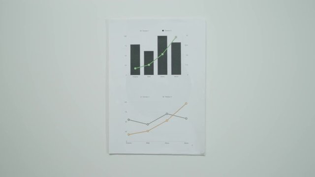 Male hands taking graphic charts.