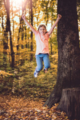 Girl jumping in the forest