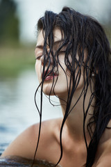 Naklejka premium Young brunette in water