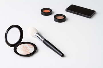 Set of decorative cosmetics over white background.