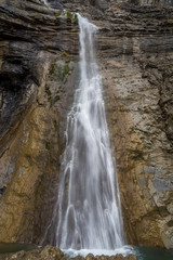 Fototapeta na wymiar Waterfall in a rugged cliff