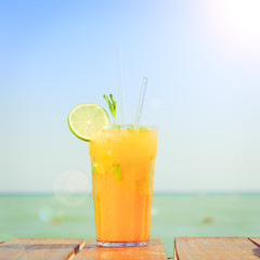Mango mojito on the wooden pier. Concept of luxury tropical vaca