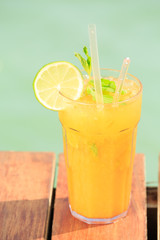 Mango mojito on the wooden pier. Concept of luxury tropical vaca