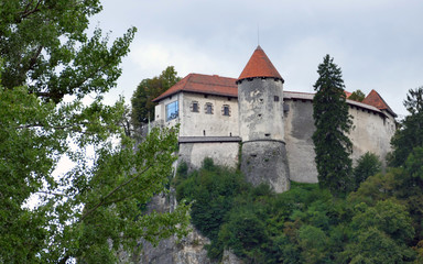 Fototapeta na wymiar Bled Castle built on top of a cliff overlooking lake Bled, locat