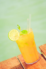 Mango mojito on the wooden pier. Concept of luxury tropical vaca