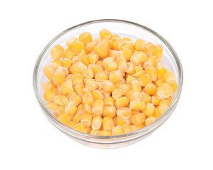Frozen organic super sweet cut corn in bowl isolated on white background