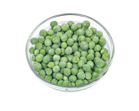 Frozen organic peas in bowl isolated on white background