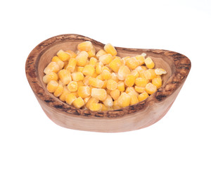 Frozen organic super sweet cut corn in olive wood bowl isolated on white background