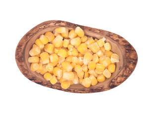 Frozen organic super sweet cut corn in olive wood bowl isolated on white background