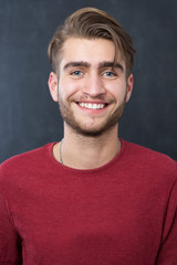sexy fashion man or student dressed casual smiling against chalk