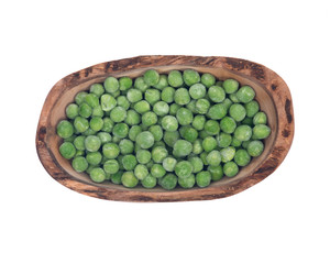 Frozen organic peas in olive wood bowl isolated on white background