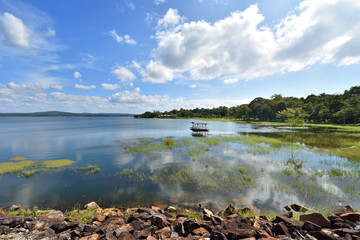Small fishing boat moored on lake in Thailand
