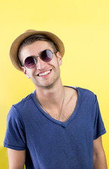 Portrait Of A Handsome Young Guy against a yellow background
