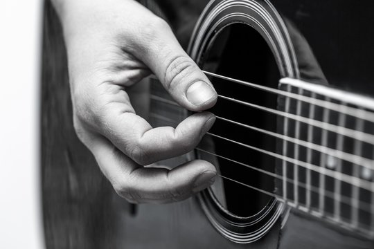 Woman hands and black acoustic guita