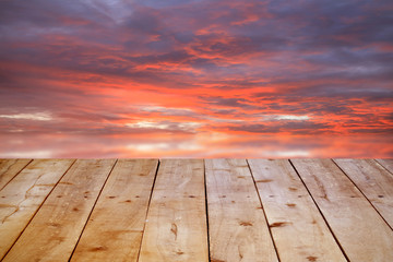 Empty wooden table on sunset