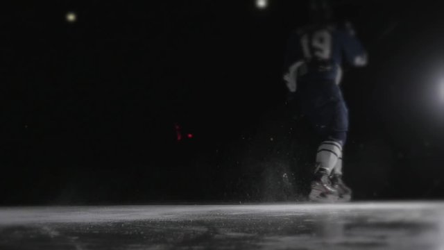 Ice hockey player shoots the puck, power slap shot in canadian style by professional athlete.