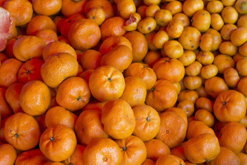 fresh orange fruit on market, orange background